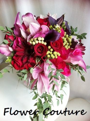 Flower Couture's rendition - unfortunately we do not have those lovely big roses, so we make do with China red roses, with dark maroon calla lilies (as requested by bride), red cymbidium orchids with bits of foliage